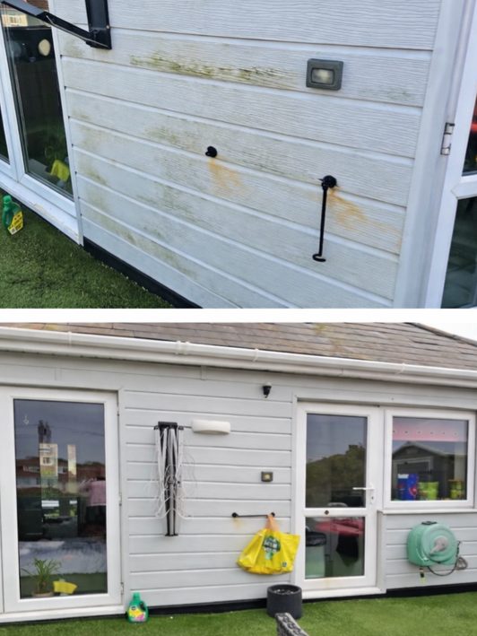 White PVC cladding on a garden room, green with algae before cleaning.