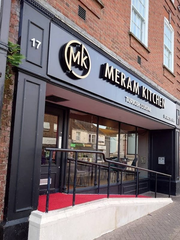 A restaurant frontage with clean glass and signage.