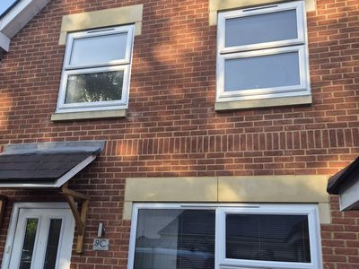 The front of a house with windows and a front door.