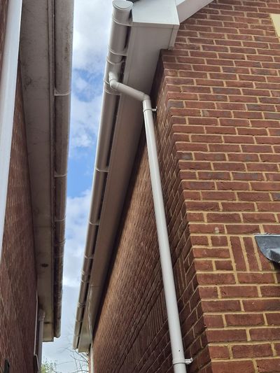 Guttering and downpipes between two houses.