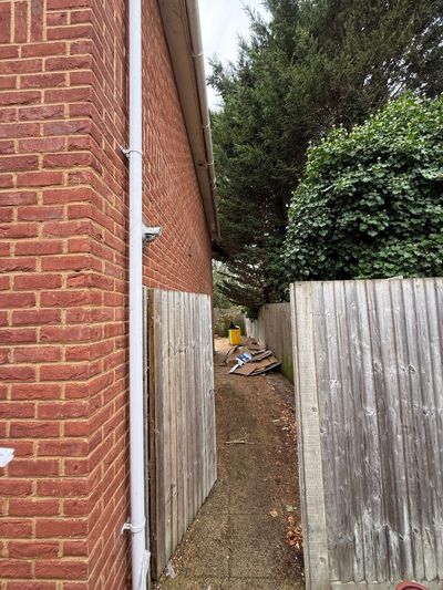 The side passage looking down towards the rear garden before cleaning.
