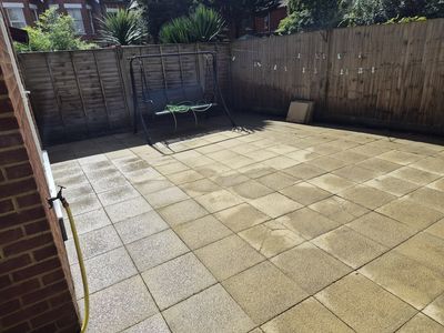 The finished patio, slabs clean and weeds gone.