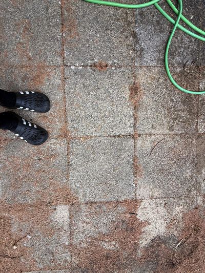 The same slabs partly cleaned, clean squares against dirty ones.