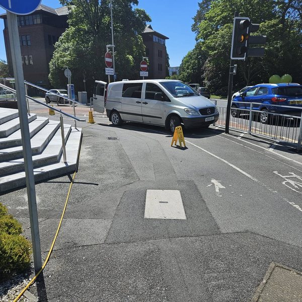 A van and wet floor signs on a commercial job.