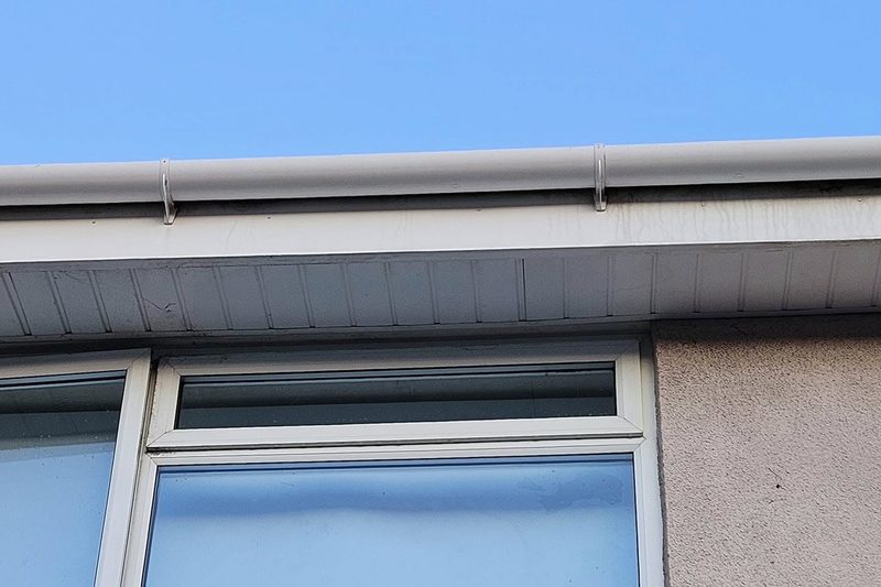 The same guttering cleaned back to white plastic.