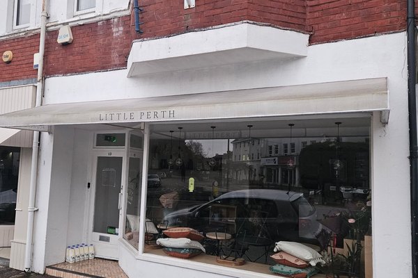 The same Little Perth shopfront after cleaning, awning and glass clear.